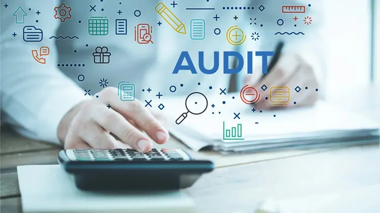 Accountant using a calculator with audit icons above