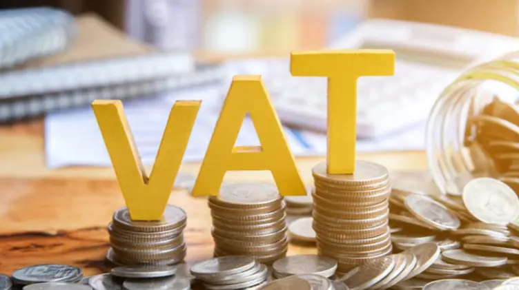Gold VAT letters standing on stacks of coins